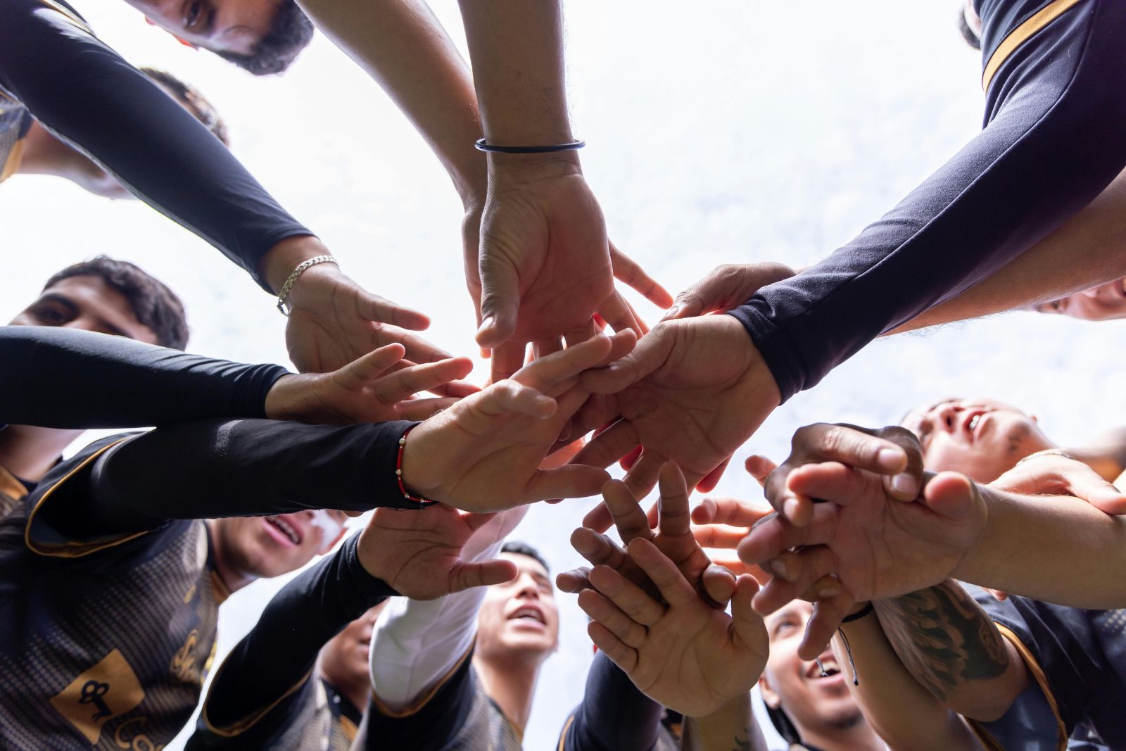 Equipo uniendo las manos en círculo